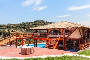 a house with a deck and a swimming pool at Estate Kares in Tílisos