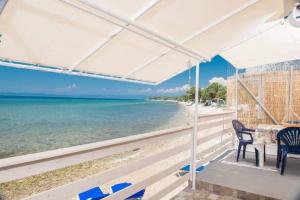 a view of the beach from the porch of a house at Julie's Hermes house in Skala Kallirachis +22 photos