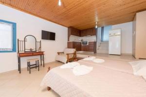 a large bedroom with a bed and a kitchen at Julie's Hermes house in Skala Kallirachis