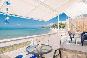 a view of the beach from the balcony of a house at Julie's Hermes house in Skala Kallirachis