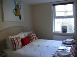 um quarto com uma cama branca e uma janela em Bow Street Runner em Brighton & Hove