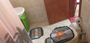 ein Badezimmer mit Toilette und zwei Körben auf dem Boden in der Unterkunft Casa Linda e Arejada in São Thomé das Letras + 32 Fotos