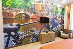 a bedroom with a view of a bridge and a bike at Vetryakov Boutique Hotel in Voronezh