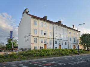 a large white building on the side of a street at EA Hotel Jeleni Dvur Prague Castle in Prague