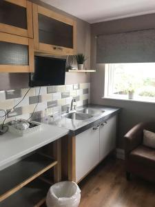 a small kitchen with a sink and a window at The Shepherd's Rest in Alnwick