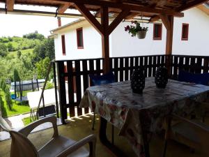 a table and chairs on a patio with a view at Colț de rai - camera de inchiriat in Reşiţa