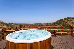 a wooden hot tub on a deck with a view at Estate Kares in Tílisos