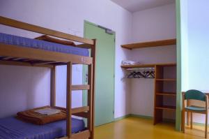 a room with two bunk beds and a chair at GITE DU MONT AIGUILLE in Chichilianne