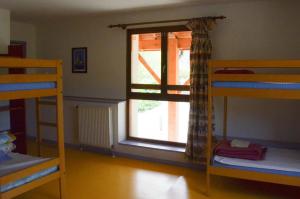 a room with three bunk beds and a window at GITE DU MONT AIGUILLE in Chichilianne