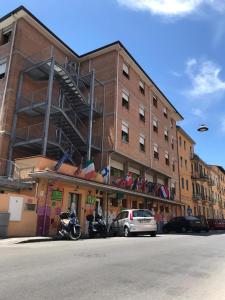 a large building with a lot of windows on the side of it at Safestay Pisa Hostel in Pisa