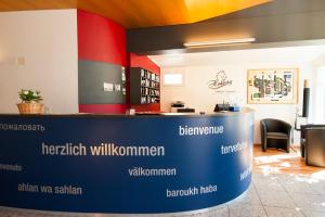 a lobby with a blue and red wall at Hotel Hohberg "Next to BBC Arena" in Schaffhausen