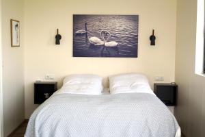 ロイガルヴァトンにあるAusturey Cottagesのベッドルーム1室(白鳥2羽の水中ベッド1台付)