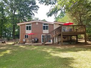 a home with a large deck and a house at Keepin' it REEL in Guntersville