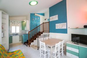 a kitchen and dining room with a table and chairs at Villa Polluce in Bibione