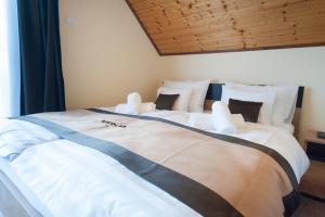 Posteľ alebo postele v izbe v ubytovaní Bier-Lak Apartman House 71