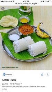 a plate with rice and a banana on a banana leaf at Kodai Elegance in Kodaikānāl