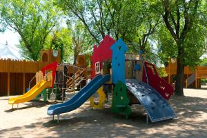 a playground with a slide in a park at New Campsite in Camping Ca' Savio in Cavallino-Treporti