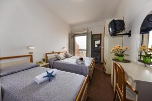 Postel nebo postele na pokoji v ubytování Hotel Caesar