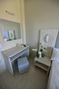 a bathroom with a table and a mirror and a bench at Capriccio Studios in Argassi