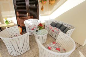 a group of white wicker chairs and a couch at Villa Lavanda in Pag