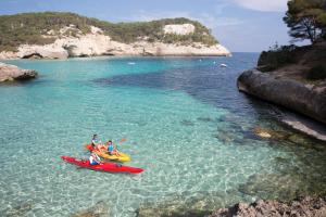 a group of people riding on a kayak in the water at ARTIEM Audax - Adults Only in Cala Galdana