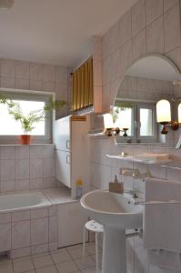 a bathroom with a sink and a refrigerator at Hostel Tolek in Warsaw