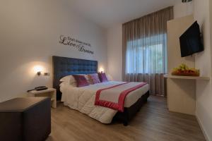 Letto o letti in una camera di Hotel Rombino