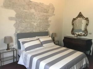 a bedroom with a bed and a stone wall at La Casa di Claudia in Florence