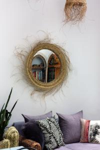 a mirror hanging on a wall next to a couch at Dar El Bali in Fez