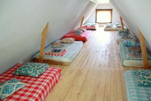a room with a bunch of beds in a attic at Pedaja Puhketalu in Nulga
