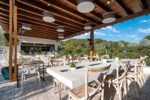 a patio with a table and chairs on a deck at ARTIEM Audax - Adults Only in Cala Galdana