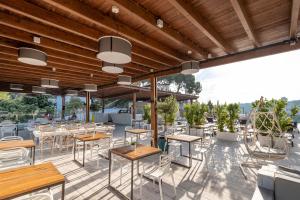 a restaurant with tables and chairs on a patio at ARTIEM Audax - Adults Only in Cala Galdana