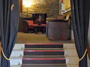 a room with two staircases and a staircase leading up to a balcony at Logis Hôtel La Fauceille in Perpignan