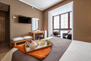 a hotel room with a tray of food on a bed at La Casa del Patrón in Murguía