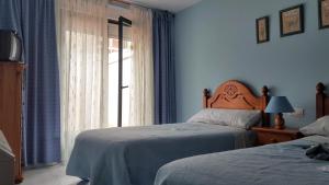 Кровать или кровати в номере kasa kala APARTAMENTO PORTONOVO SANXENXO