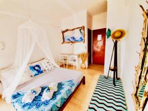 a bedroom with a bed with a canopy at Thomas Art Hotel in Pelekas
