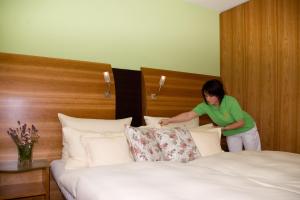 Postel nebo postele na pokoji v ubytování Astralis Hotel Domizil