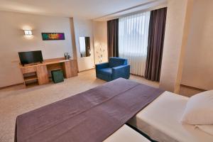 TV a/nebo společenská místnost v ubytování Terra Europe Brontes Hotel