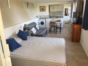 a bedroom with a bed and a living room at Magnifique Studio in Sète
