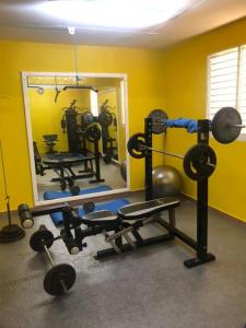 a gym with a mirror and some equipment in a room at Le Papillon in Le Moule