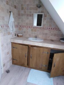 a bathroom with a sink and a mirror at L'Tas De Cailloux in Cancale