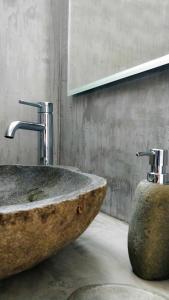 uma casa de banho com um lavatório de pedra e duas torneiras em Viva Mare Traditional Studios em Astypalaia