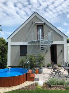 a house with a swimming pool in front of it at Riza villa in Badacsonytomaj