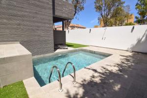 a swimming pool in the backyard of a house at Letmalaga Carlos Haya in Málaga