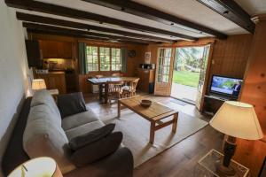 a living room with a couch and a table at Rose de Noël in Les Diablerets