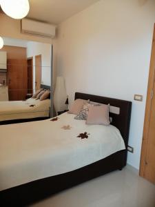 a bedroom with a large bed and a mirror at Studio Apartman Irena 2 in Bijela
