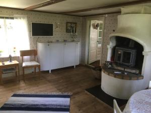 a living room with a wood stove in a room at Tubbared. in Ullared