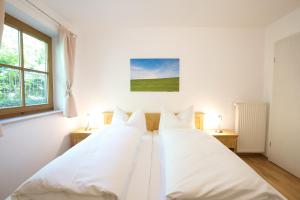 three beds in a room with white walls at Rettenberger Murmele in Rettenberg
