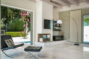 A television and/or entertainment centre at Aloni Villa - Contemporary Villa with Private Pool & Sea Views, Fiskardo