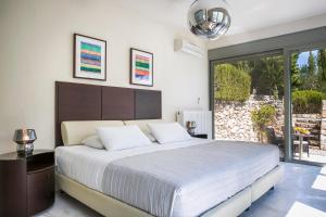 A bed or beds in a room at Aloni Villa - Contemporary Villa with Private Pool & Sea Views, Fiskardo